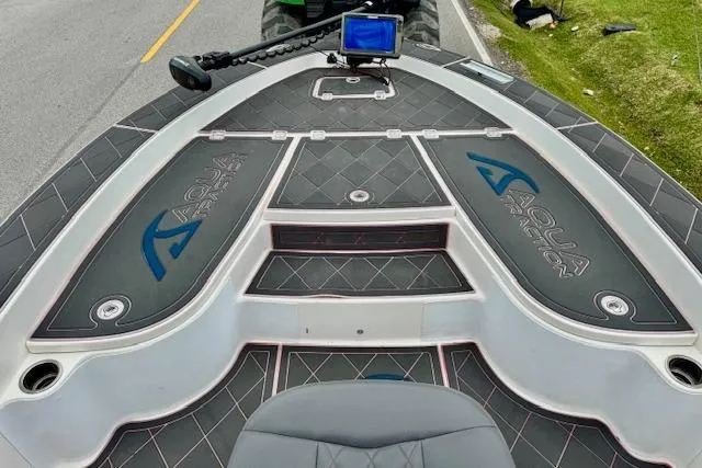 Slide: The Image of 2015 Robalo 226 Cayman boat deck with Aqua Traction flooring and navigation equipment. - 13