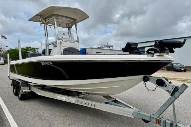 Slide: The Image of 2015 Robalo 226 Cayman boat on trailer, black and white design, parked outdoors. - 5