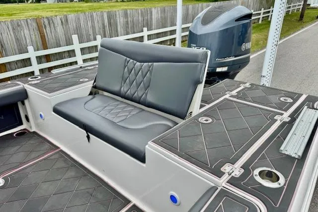 Slide: The Image of 2015 Robalo 226 Cayman boat with cushioned seating and Yamaha outboard motor. - 7