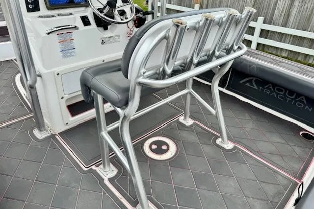 Slide: The Image of 2015 Robalo 226 Cayman boat interior with rod holders and steering console. - 8