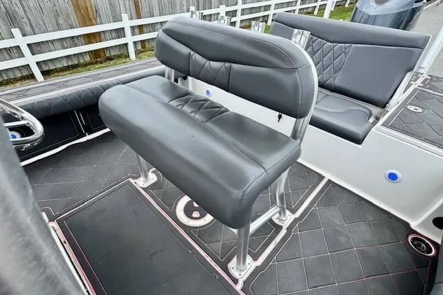 Slide: The Image of 2015 Robalo 226 Cayman boat interior with black cushioned seating and sleek design. - 9