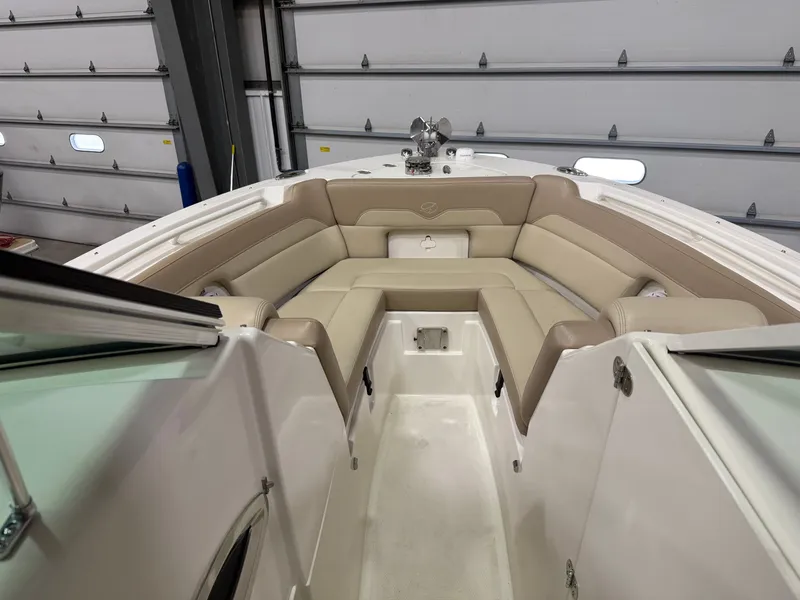 Slide: The Image of Interior of a 2018 Sailfish 245 DC boat with beige seating. - 10