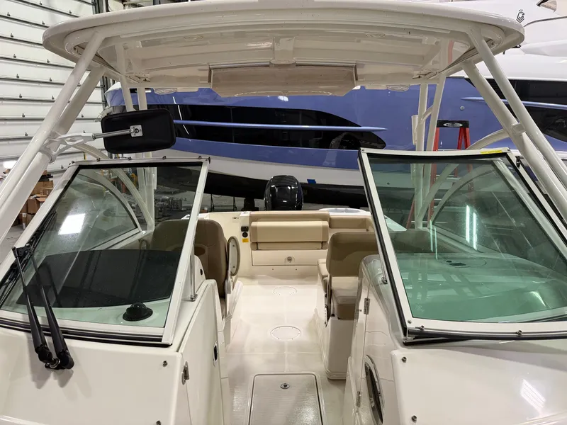 Slide: The Image of Interior view of a 2018 Sailfish 245 DC boat in a storage facility. - 12