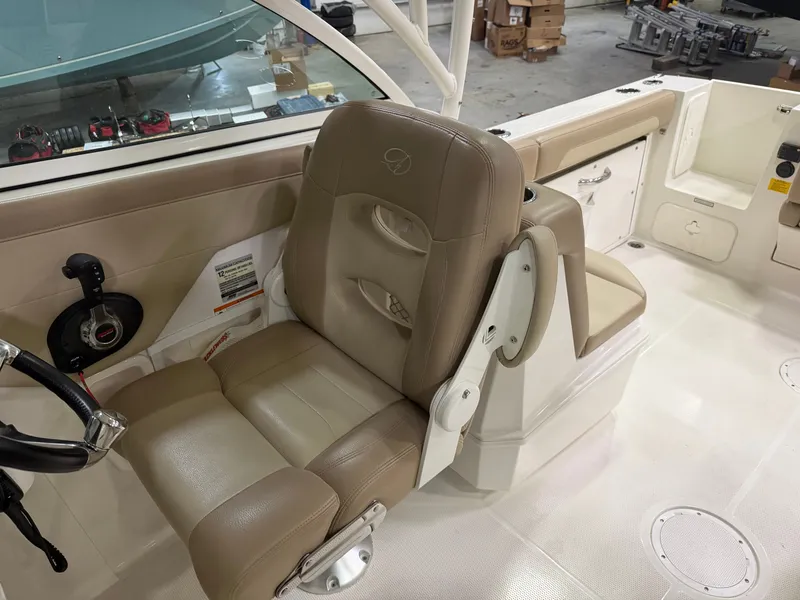 Slide: The Image of Interior of a 2018 Sailfish 245 DC boat with beige seating. - 13