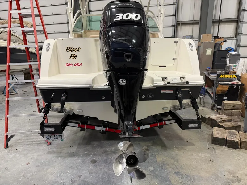 Slide: The Image of 2018 Sailfish 245 DC boat with outboard motor in a workshop. - 16