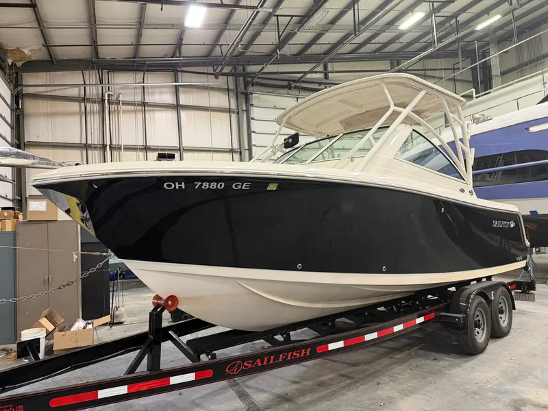 Slide: The Image of 2018 Sailfish 245 DC boat in warehouse on trailer. - 2