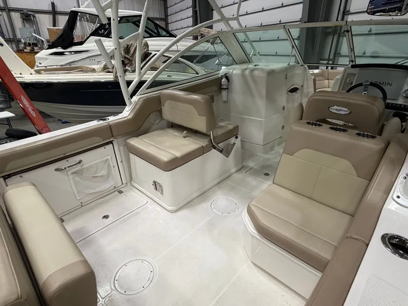 Slide: The Image of Interior of a 2018 Sailfish 245 DC boat with beige seating. - 3