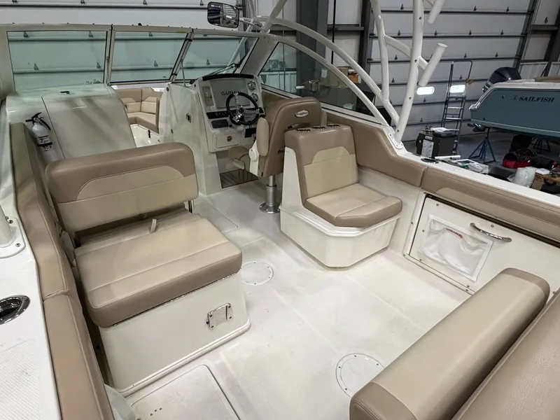 Slide: The Image of Interior of a 2018 Sailfish 245 DC boat with beige seating. - 4