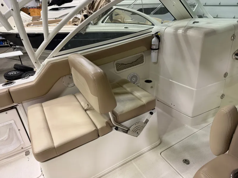 Slide: The Image of Interior of a 2018 Sailfish 245 DC boat with beige seating. - 7