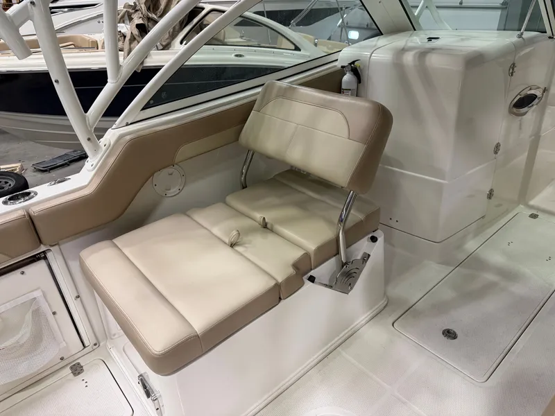 Slide: The Image of Interior of a 2018 Sailfish 245 DC with beige seating. - 8
