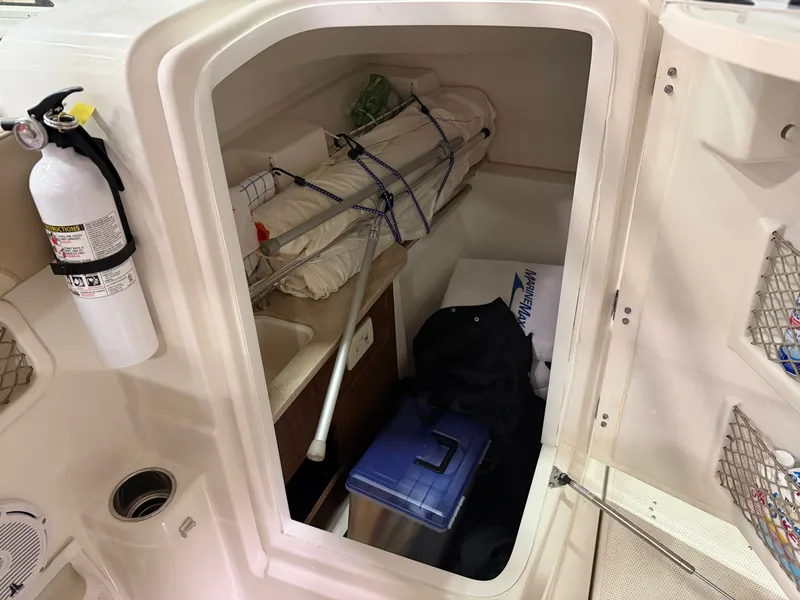 Slide: The Image of Interior of 2018 Sailfish 245 DC with storage and fire extinguisher. - 9