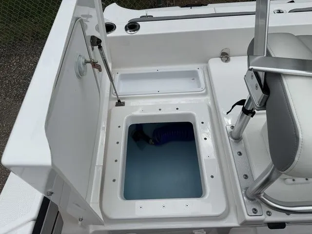 Slide: The Image of Yamaha Boats 195 FSH Sport 2025, open storage compartment and seating area. - 13