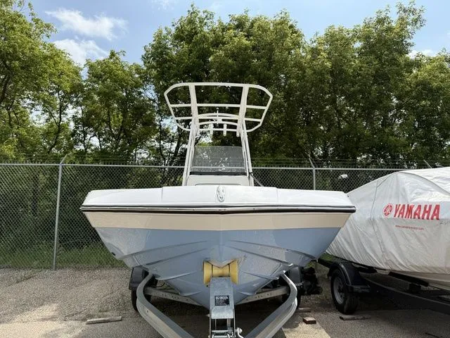 Slide: The Image of 2025 Yamaha Boats 195 FSH Sport in front of trees and fence. - 3