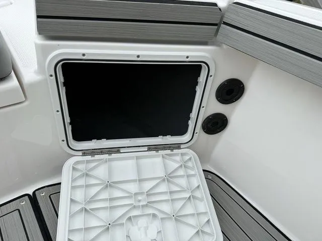Slide: The Image of Yamaha Boats 195 FSH Sport 2025 storage compartment with open lid. - 38