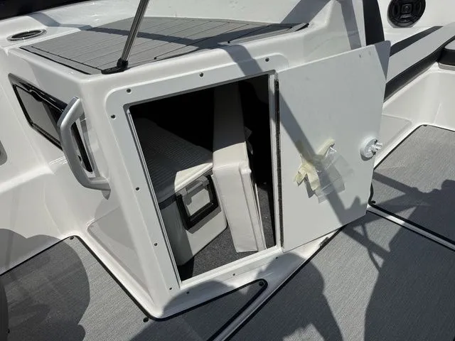 Slide: The Image of Storage compartment in 2025 Yamaha SX195 boat with open door. - 19