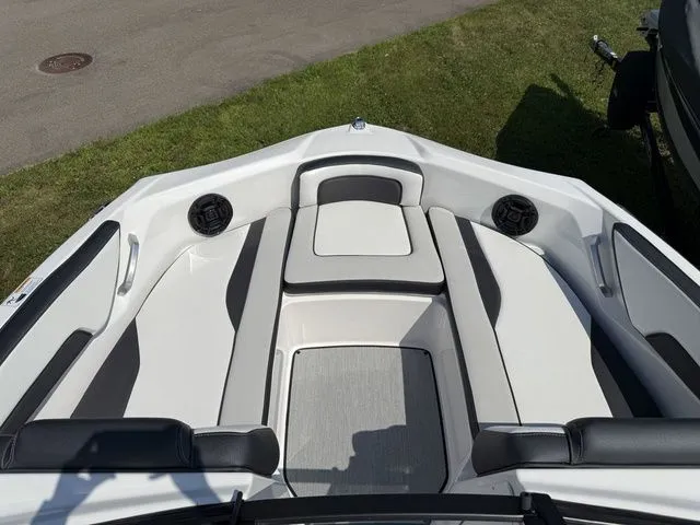 Slide: The Image of Interior view of 2025 Yamaha Boats SX195 with gray and white seating. - 22