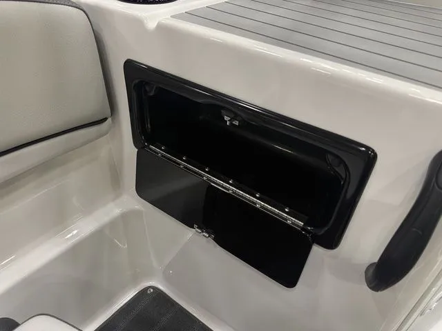 Slide: The Image of Interior of 2026 Yamaha SX190 boat featuring storage compartment. - 19