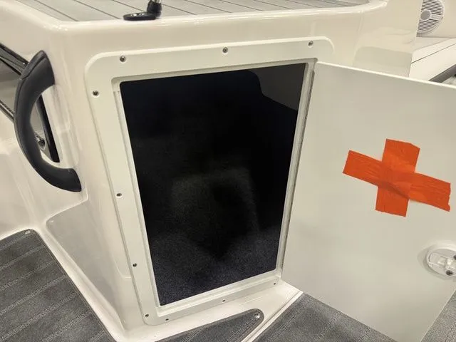 Slide: The Image of Storage compartment in 2026 Yamaha SX190 boat with open door. - 20