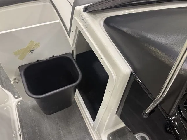 Slide: The Image of 2026 Yamaha SX190 boat interior with storage compartment and trash bin. - 21