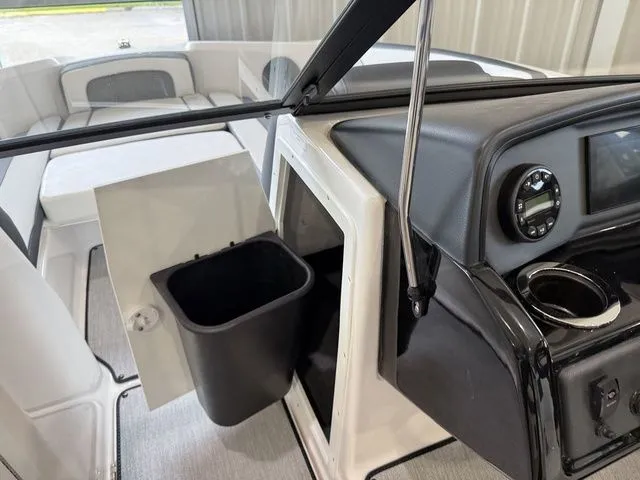Slide: The Image of Interior of 2025 Yamaha SX195 boat with trash bin and dashboard. - 24
