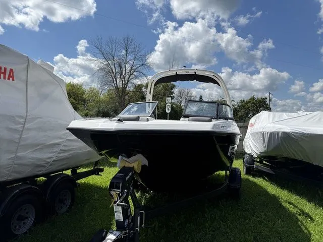 Slide: The Image of 2025 Yamaha AR190 boat on trailer under cloudy sky. - 2