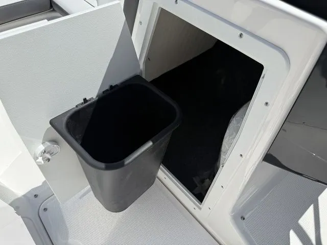 Slide: The Image of Yamaha Boats AR190 2025 storage compartment with trash bin. - 24