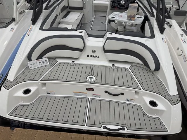 Slide: The Image of Yamaha AR195 2025 boat rear with gray deck and seating area. - 3