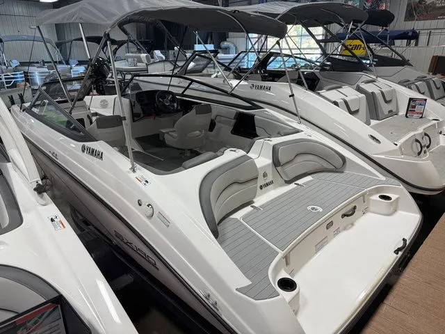 Slide: The Image of 2024 Yamaha SX190 boat in showroom, white design, modern features. - 4