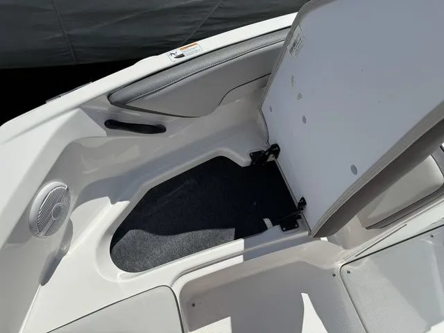 Slide: The Image of Yamaha Boats AR190 2025 storage compartment with open lid. - 27