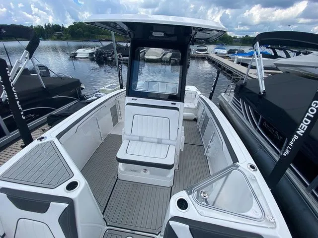 Slide: The Image of 2024 Yamaha Boats 255 FSH Sport H on a serene lake. - 19