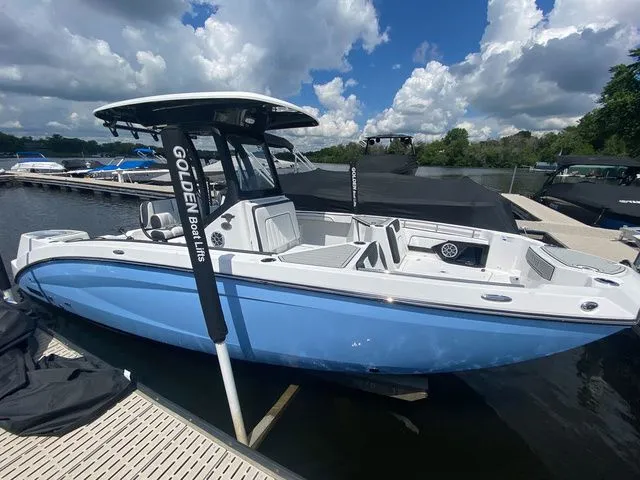 Slide: The Image of 2024 Yamaha Boats 255 FSH Sport H in blue at the dock. - 4