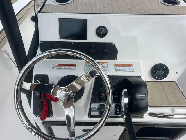 Slide: The Image of Yamaha Boats 2024 190 FSH Sport helm with steering wheel and controls. - 10