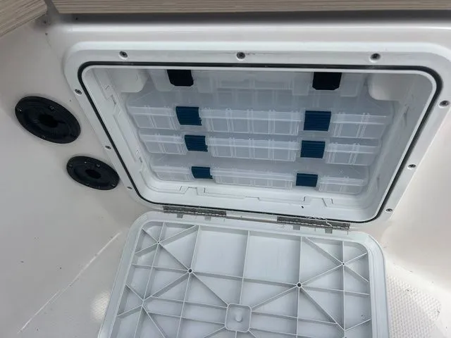Slide: The Image of Open storage compartment in 2024 Yamaha Boats 190 FSH Sport. - 19