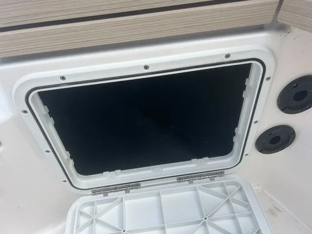 Slide: The Image of Open storage compartment on Yamaha 190 FSH Sport 2024 boat. - 25