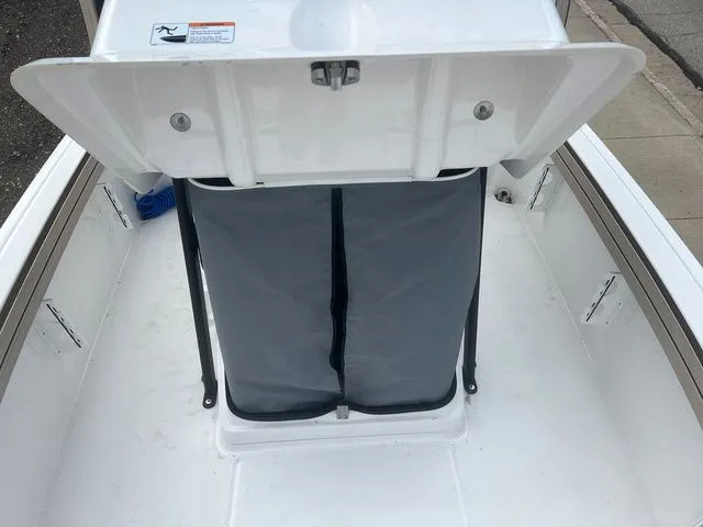 Slide: The Image of Yamaha Boats 2024 190 FSH Sport storage compartment with gray cover. - 27