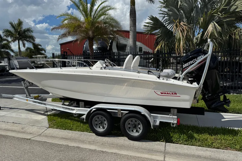 Slide: The Image of 2017 Boston Whaler 170 Super Sport boat on trailer, parked outdoors. - 3