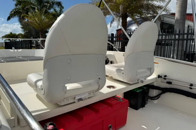 Slide: The Image of 2017 Boston Whaler 170 Super Sport interior with white seats and red storage box. - 30