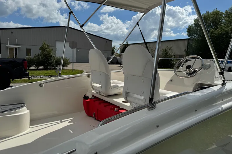 Slide: The Image of 2017 Boston Whaler 170 Super Sport boat interior with seats and steering wheel. - 32