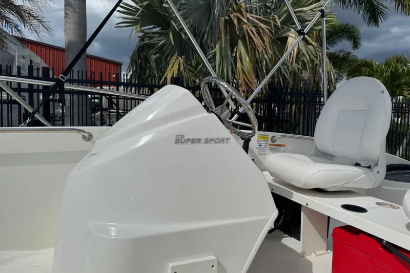 Slide: The Image of 2017 Boston Whaler 170 Super Sport boat interior with steering wheel and white seating. - 39