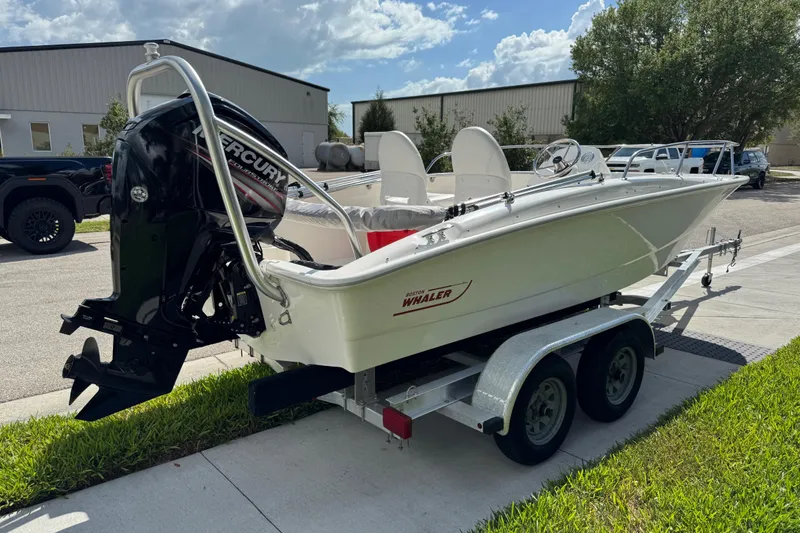 Slide: The Image of 2017 Boston Whaler 170 Super Sport boat on trailer, featuring Mercury outboard motor. - 8