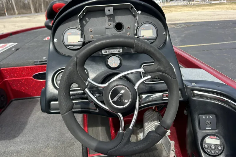 Slide: The Image of Steering wheel and dashboard of a 2007 Skeeter 20i boat, featuring gauges and controls. - 11