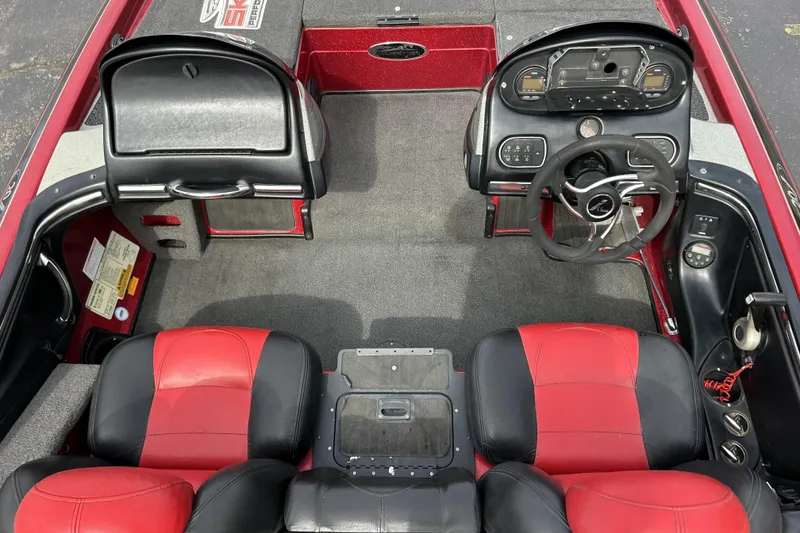 Slide: The Image of 2007 Skeeter 20i boat interior with red and black seating, steering wheel, and dashboard controls. - 18