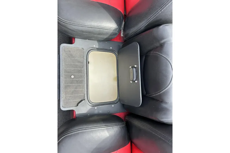 Slide: The Image of 2007 Skeeter 20i boat interior storage compartment with black and red seating. - 24