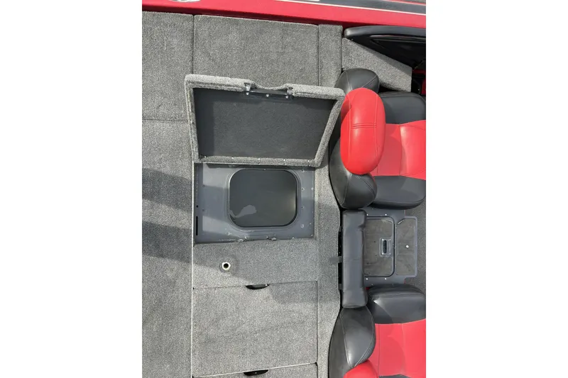 Slide: The Image of 2007 Skeeter 20i boat interior with open storage compartment and red-black seats. - 26