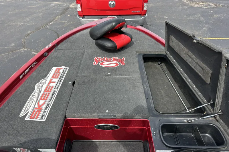 Slide: The Image of 2007 Skeeter 20i fishing boat deck with storage compartments and red accents. - 27
