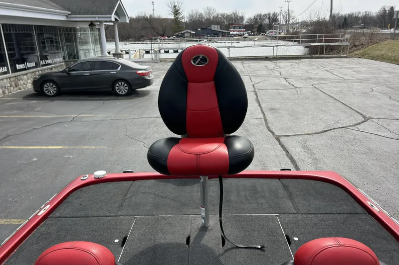 Slide: The Image of Red and black seat on 2007 Skeeter 20i boat, parked near a waterfront. - 29