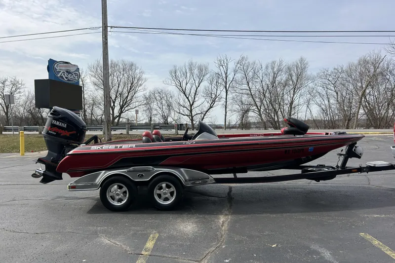 Slide: The Image of 2007 Skeeter 20i bass boat with Yamaha engine on trailer in parking lot. - 4