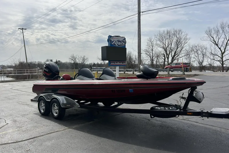 Slide: The Image of 2007 Skeeter 20i bass boat on trailer in parking lot, overcast sky. - 5