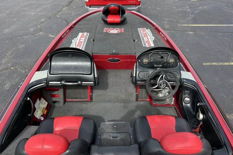 Slide: The Image of 2007 Skeeter 20i boat interior with red and black seating, dashboard, and steering wheel. - 9