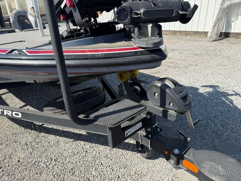 Slide: The Image of 2021 Nitro Z20 boat trailer with winch on gravel surface. - 22